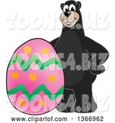 Vector Illustration of a Cartoon Black Bear School Mascot with an Easter Egg by Mascot Junction