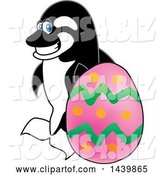 Vector Illustration of a Cartoon Killer Whale Orca Mascot with an Easter Egg by Mascot Junction