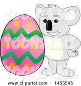 Vector Illustration of a Cartoon Koala Bear Mascot with an Easter Egg by Mascot Junction