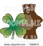 Vector Illustration of a Cartoon Grizzly Bear School Mascot with a Four Leaf St Patricks Day Clover by Mascot Junction