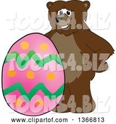 Vector Illustration of a Cartoon Grizzly Bear School Mascot with an Easter Egg by Mascot Junction