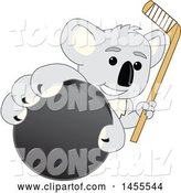 Vector Illustration of a Cartoon Koala Bear Mascot Holding a Hockey Stick and Grabbing a Puck by Mascot Junction
