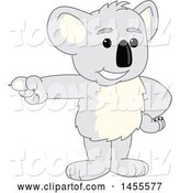 Vector Illustration of a Cartoon Koala Bear Mascot Pointing by Mascot Junction