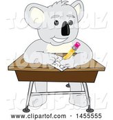 Vector Illustration of a Cartoon Koala Bear Mascot Student Writing at a Desk by Mascot Junction