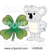 Vector Illustration of a Cartoon Koala Bear Mascot with a St Patricks Day Four Leaf Clover by Mascot Junction