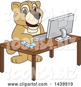 Vector Illustration of a Cartoon Lion Cub School Mascot Using a Computer by Mascot Junction