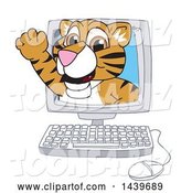 Vector Illustration of a Cartoon Tiger Cub Mascot Emerging from a Computer Screen by Mascot Junction