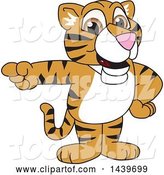 Vector Illustration of a Cartoon Tiger Cub Mascot Pointing by Mascot Junction