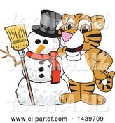 Vector Illustration of a Cartoon Tiger Cub Mascot with a Snowman by Mascot Junction