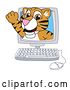 Vector Illustration of a Cartoon Tiger Cub Mascot Emerging from a Computer Screen by Mascot Junction
