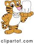Vector Illustration of a Cartoon Tiger Cub Mascot Holding a Tooth by Toons4Biz