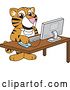 Vector Illustration of a Cartoon Tiger Cub Mascot Using a Computer by Mascot Junction